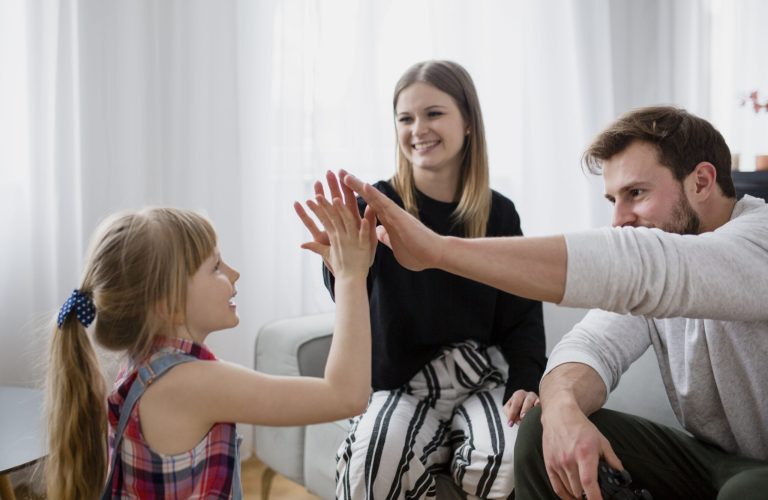 family-high-fiving-living-room